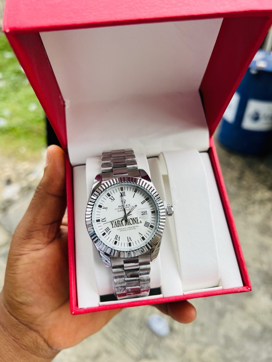 Silver male face engraved Rolex watch