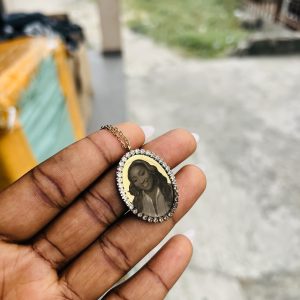 Gold stoned oval picture engraved necklace