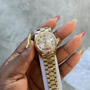 Roman gold white face female Rolex watch